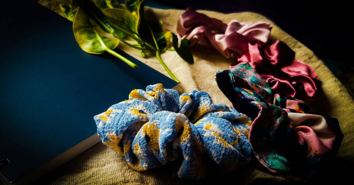 Eye-catching hair ties arranged on a marble surface with textured hair spikes styled nearby